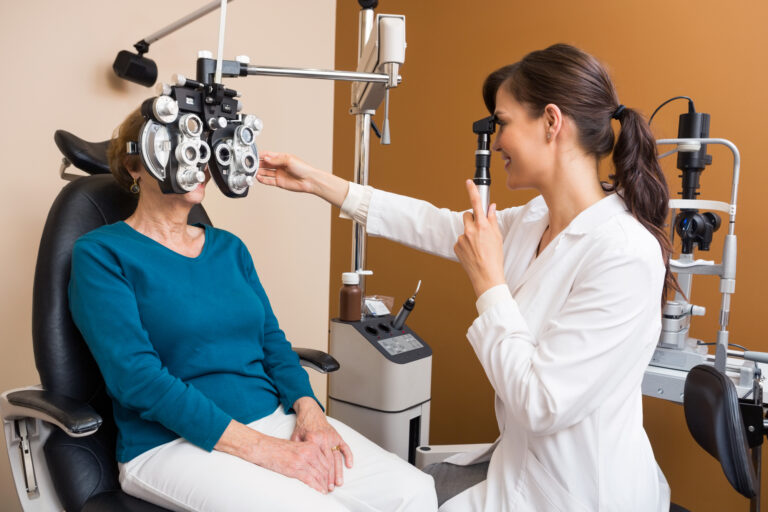 Optometrist Examining Senior Womans Eyes using a Retinoscope 768x512 1