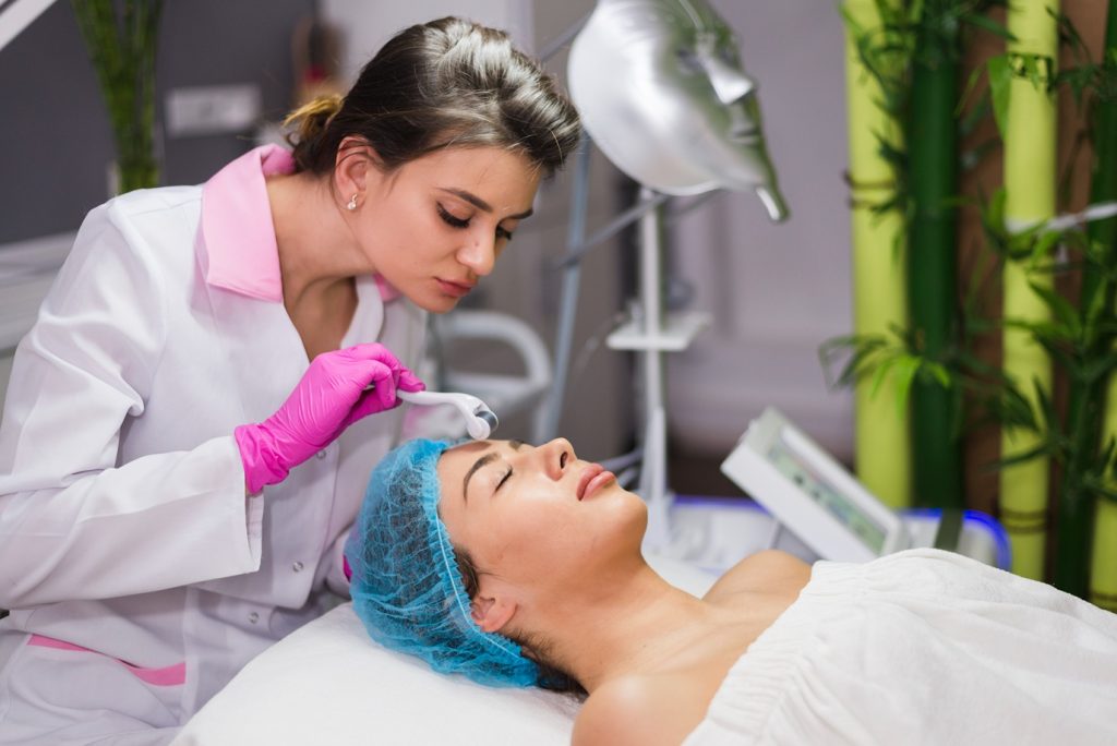 girl receiving facial treatment beauty salon 1 1